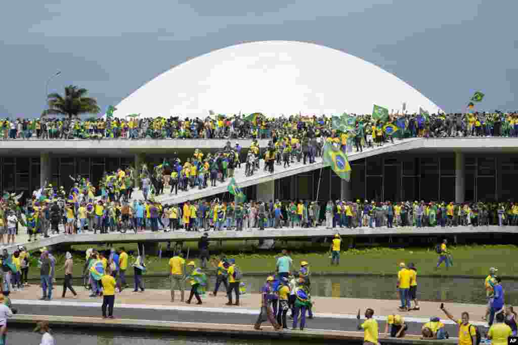 Supporters of Brazil's former President Jair Bolsonaro storm the the National Congress building in Brasilia, Brazil, Jan. 8, 2023. 