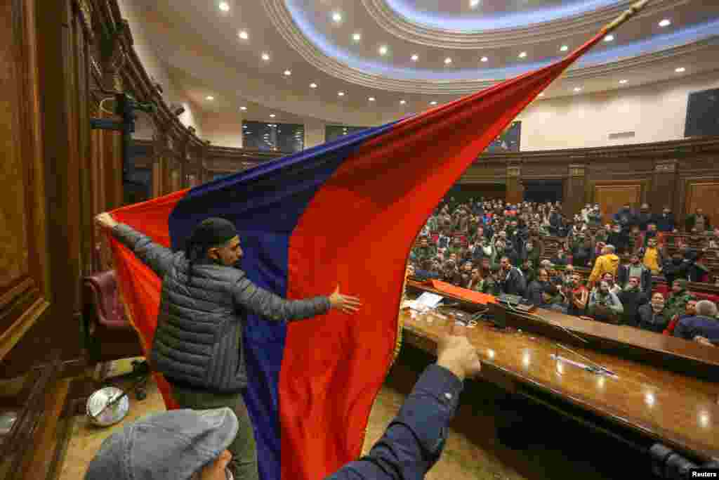 People storm the parliament in Yerevan, Armenia, after Prime Minister Nikol Pashinyan said he had signed an agreement with leaders of Russia and Azerbaijan to end the war.