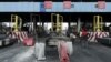 FILE - Workers clean up the Lekki toll gate, the site where soldiers had opened fire on protesters rallying against alleged police brutality, in Lagos, Nigeria, Oct. 24, 2020. 