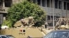 Egyptian army armoured personnel carriers (APC) are stationed outside the Aguza Military Hospital in Cairo, August 19, 2013.