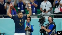 Kylian Mbappe celebrates after scoring France's third goal during the World Cup round of 16 soccer match against Poland at the Al Thumama Stadium in Doha, Qatar, Dec. 4, 2022.