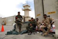 FILE - Afghan security forces keep watch after the American military left Bagram Airfield, in Parwan province north of Kabul, Afghanistan, July 5, 2021.