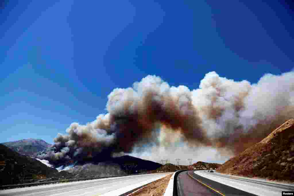 A huge plume of smoke crosses over Interstate 15 during the Blue Cut fire at the Cajon Pass in San Bernardino County, California.