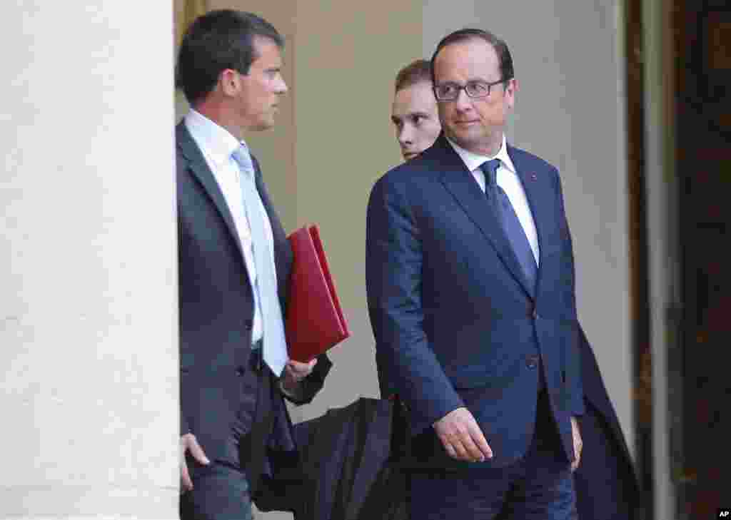 French Prime Minister Manuel Valls, left, leaves with French President Francois Hollande after a meeting at the Elysee Palace in Paris, Aug. 25, 2014. 
