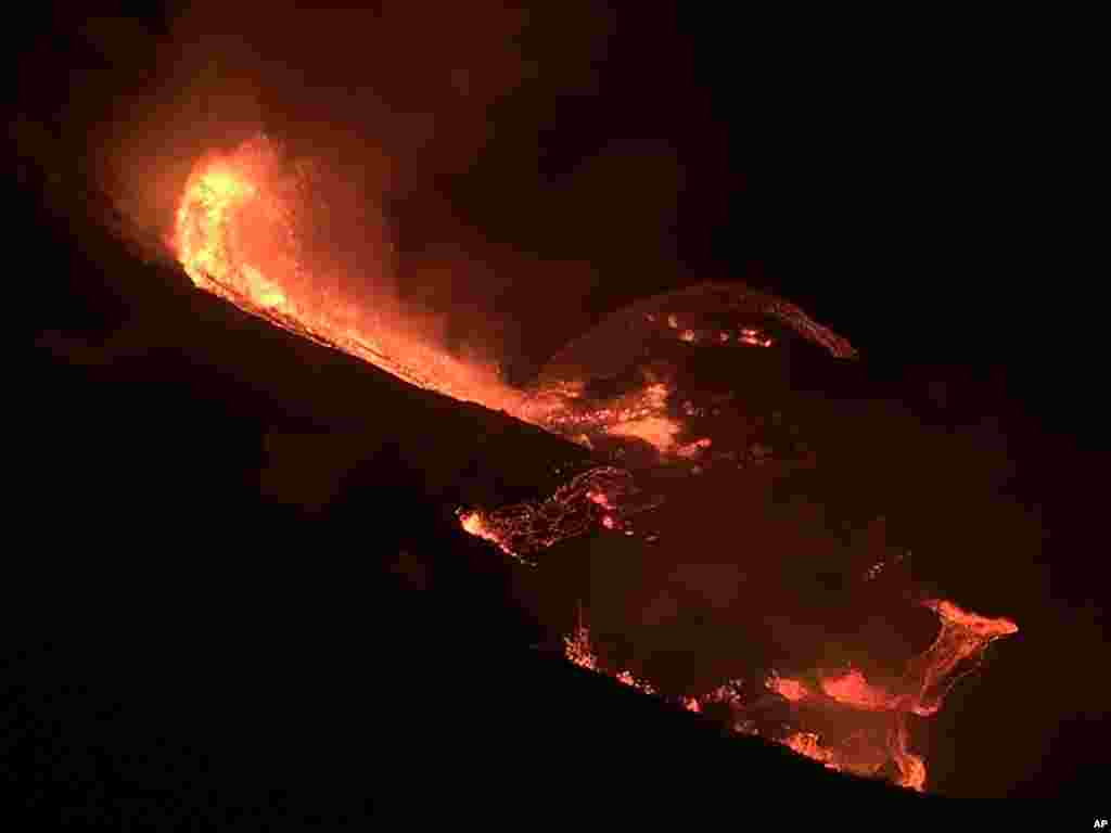 In this photo provided by the U.S. Geological Survey, lava flows from the Halema’uma’u crater of the Kilauea volcano in Hawaii, Dec. 20, 2020.