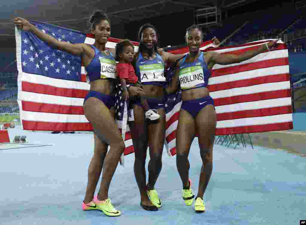 Gold medal winner Brianna Rollins, silver medal winner, Nia Ali, and bronze medal winner Kristi Castlin,all from the United States, celebrate with their country's flag during the athletics competitions of the 2016 Summer Olympics at the Olympic stadium in Rio de Janeiro, Brazil.
