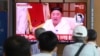 People watch a screen showing a file image of North Korean leader Kim Jong Un during a news program at the Seoul Railway Station in Seoul, South Korea, Sept. 25, 2020. 