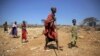 FILE - Elijah Leshakwet, 4, and her grandmother, Marseyian Letooye, walk in Samburu County, Kenya, on Oct. 13, 2022. A U.S. official said Feb. 1, 2023, that there is an urgent need to develop crops that can withstand climate change and feed Africa’s growing population.