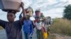 Displaced families from the community of Impire, a town in the district of Metuge in the Cabo Delgado province, flee armed insurgents on June 14, 2022.