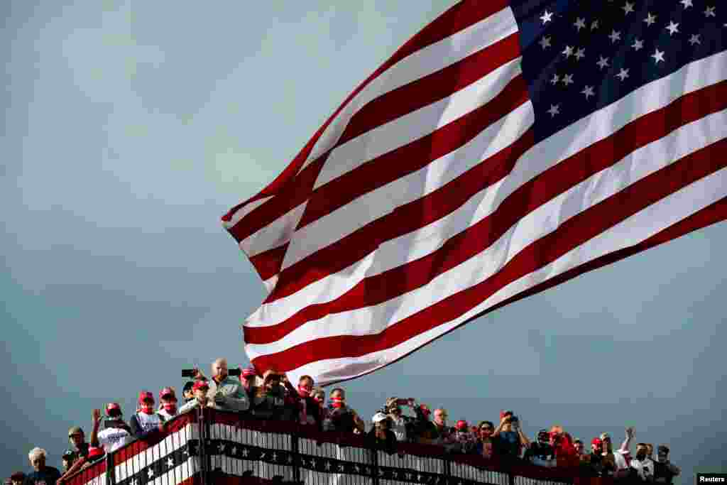 Supporters are seen before the start of a U.S. President Donald Trump's campaign event at Des Moines International Airport in Des Moines, Iowa, Oct. 14, 2020.