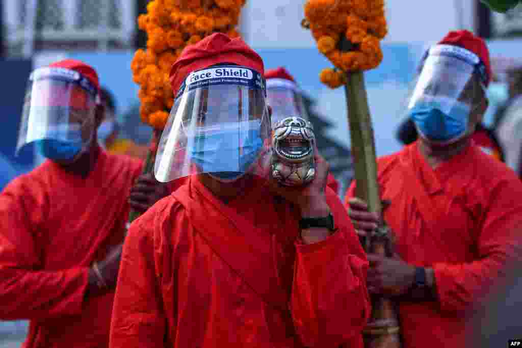 Devotees carry jamara plants used for blessings during the Fulpati procession marking the seventh day of the Nepali Hindu festival 'Dashain' in Kathmandu, Nepal.