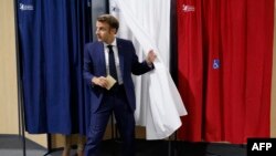 France's President Emmanuel Macron leaves the polling booth to casts his vote in French parliamentary elections at a polling station in Le Touquet, northern France, June 12, 2022.
