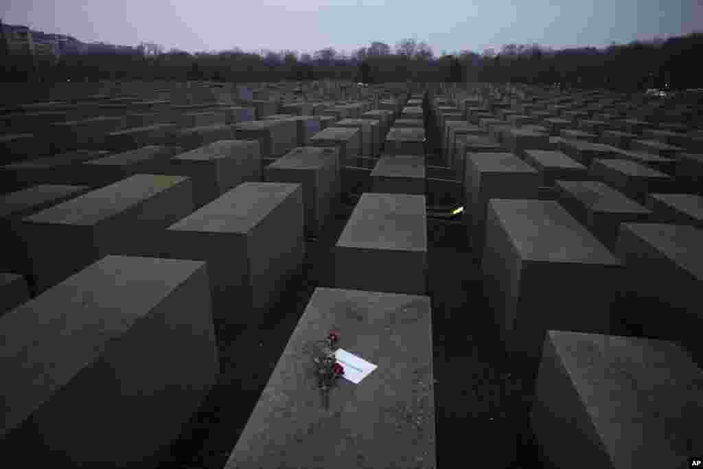 Roses with a note saying "#weremember", are placed on the Holocaust Memorial on International Holocaust Remembrance Day, in Berlin, Germany.