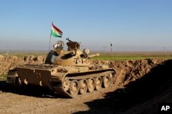 FILE - In this Jan. 20, 2015, file photo released by the Kurdistan Region Security Council, Kurdish peshmerga forces prepare on the front line for battle against Islamic State group positions, in northern Iraq.