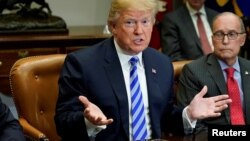 FILE - U.S. President Donald Trump and White House chief economic adviser Larry Kudlow are seen at a meeting with chief executives of major automakers at the White House in Washington, May 11, 2018.