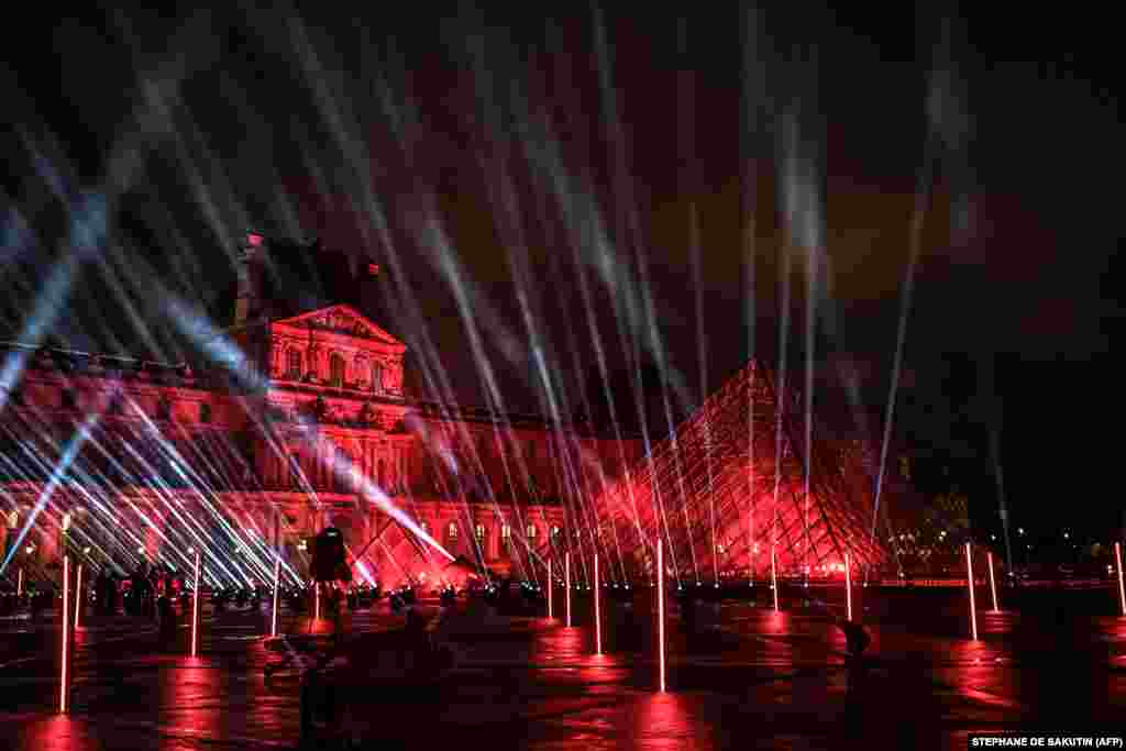 The stage set up for French DJ David Guetta's 2021 New Year's eve livestream charity concert "United at Home" is in the Cour Napoleon, with the Louvre Pyramid, designed by Ieoh Ming Pei, in Paris, France, Dec. 29, 2020.