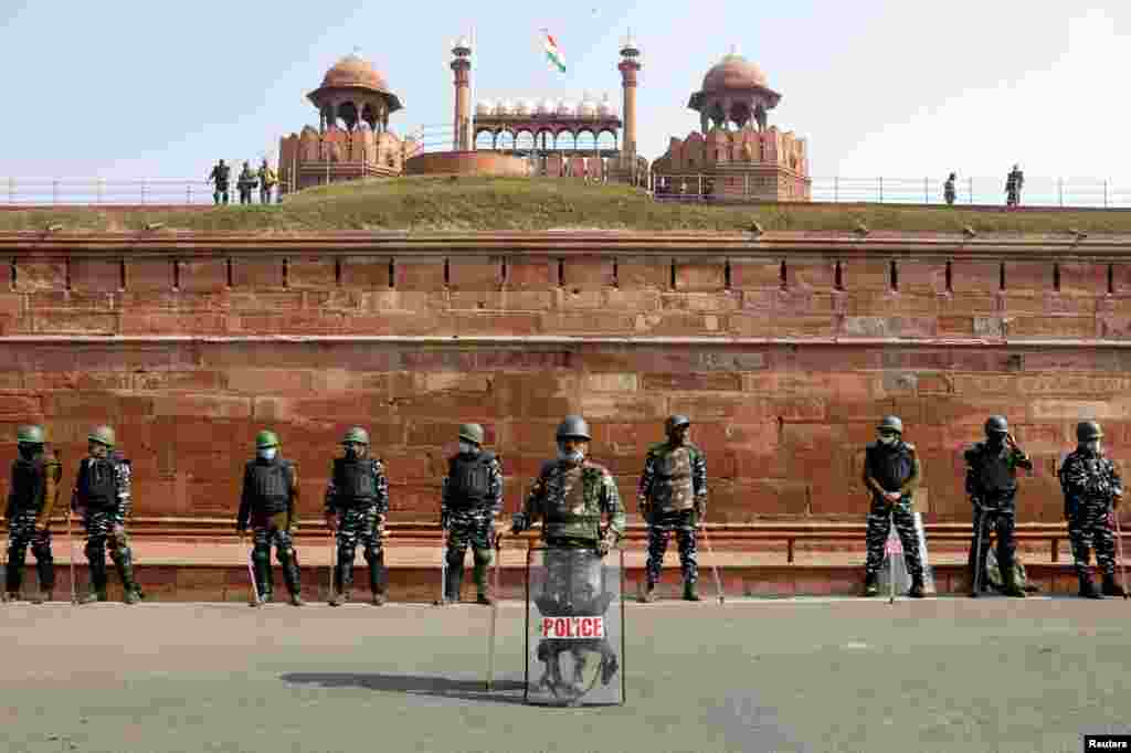 Policemen stand guard in front of the historic Red Fort after Tuesday's clashes between police and farmers, in the old quarters of Delhi, India.