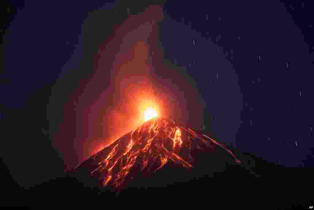 Lava flows down from the crater of the Volcan de Fuego, or Volcano of Fire, in Alotenango, Guatemala, Feb. 14, 2021.