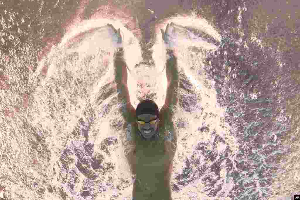 Al Kulaibi Mskm of Oman competes in the men's 100-meter butterfly heat at the World Aquatics Championships in Doha, Qatar.