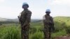FILE - UN peacekeepers from Tanzania hold their weapons as they patrol outside Goma.