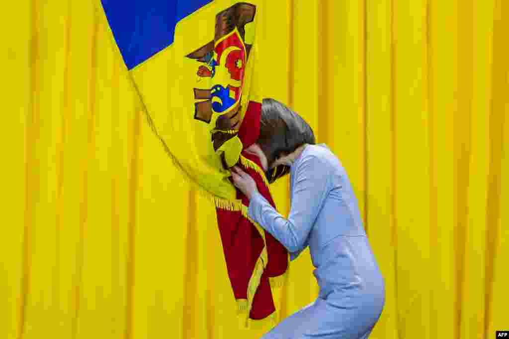 Moldova's President-elect Maia Sandu kisses the national flag during her inauguration ceremony in Chisinau.