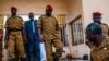 Burkina Faso Lt. Col. Issac Yacouba Zida, center, leaves a government building after meeting with political leaders in Ouagadougou, Burkina Faso, Nov. 4, 2014. 