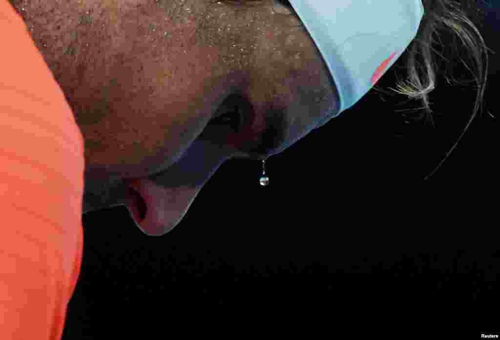 A bead of sweat drips from Spain's Rafael Nadal during his second round match against Michael Mmoh of the U.S. at the Australian Open tennis championship in Melbourne.
