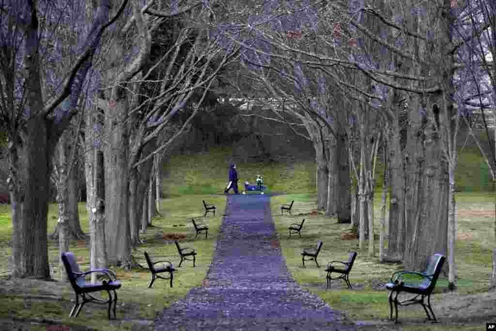A couple of youngsters get a ride in a wagon at Capitol Park, Dec. 2, 2020, in Augusta, Maine.