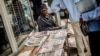 A Street vendor sells newpapers with elections headlines at a central street, Oct. 16, 2014 in Maputo. 