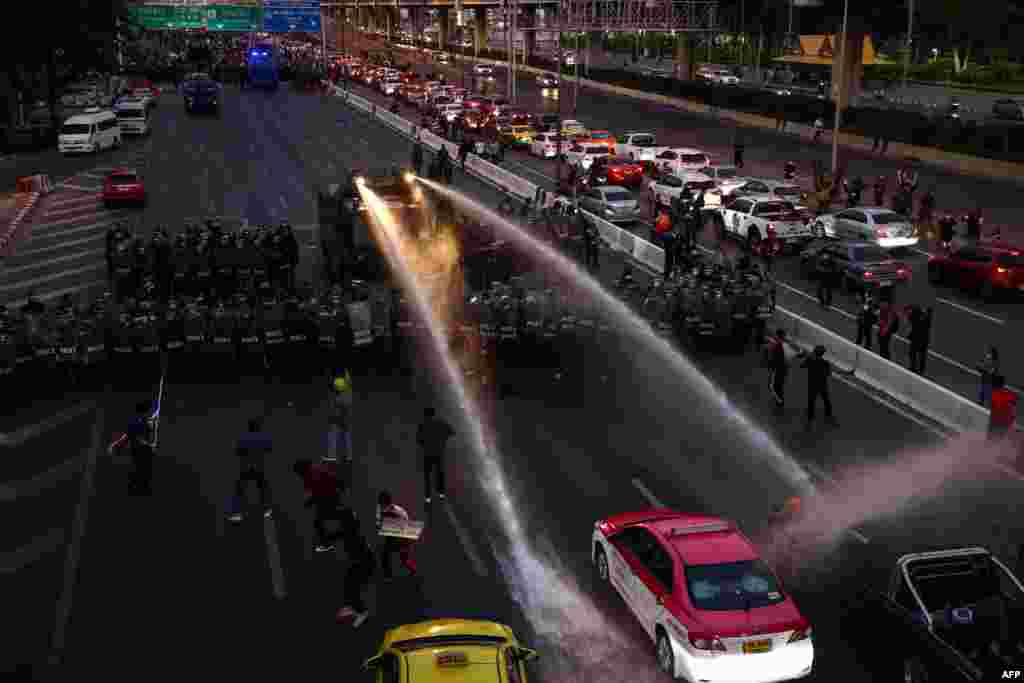 Police us a water cannon to disperse pro-democracy protesters marching toward the residence of Thailand's Prime Minister Prayut Chan-O-Cha in Bangkok.