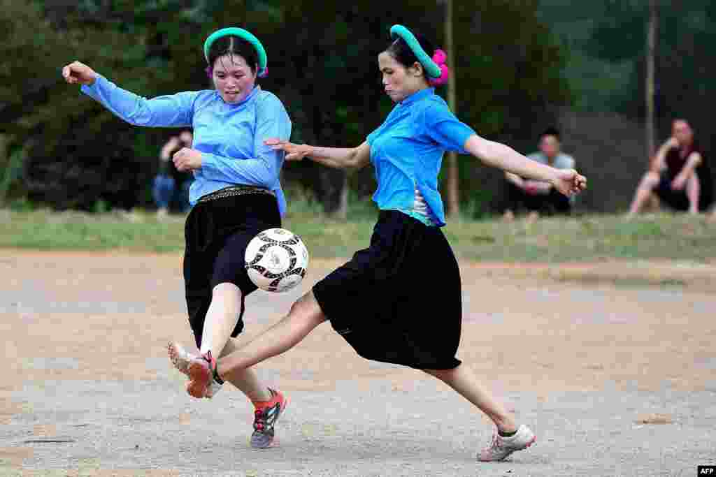 Ethnic San Chi women dressed in traditional costumes play a friendly football match as part of the Soong Co festival celebrations in northern Vietnam's Quang Ninh province.