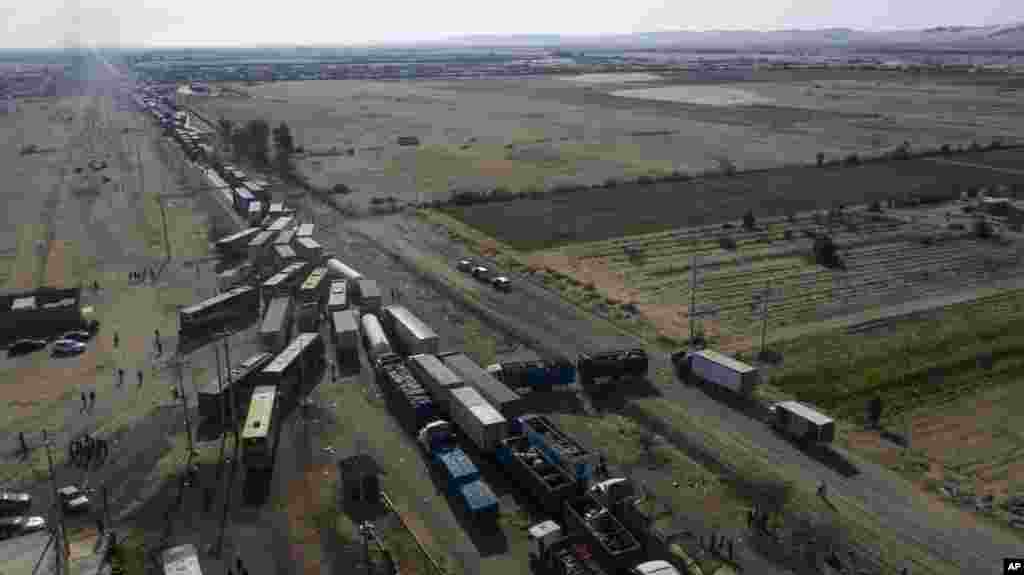 Trucks sit idle on the Pan-American South Highway during a blockade set up by farmworkers, on the fourth day of protests against the Agricultural Promotion Law, in Villacuri, Ica province, Peru.