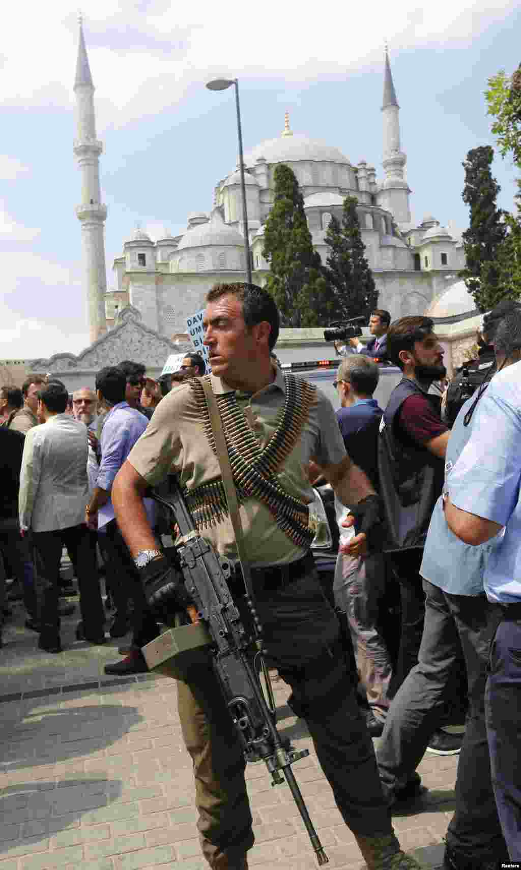 Penembak jitu bersenjata menjaga kendaraan Presiden Recep Tayyip Erdogan setelah upacara pemakaman para korban kudeta yang gagal, di masjid Fatih, Istanbul (17/7). (Reuters/Murad Sezer)