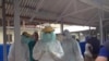 Cuban medical team training in personal protective equipment (PPE) at an Ebola center being built in Waterloo, east of Freetown, Sierra Leone, Nov. 17, 2014. (Nina deVries/VOA) 