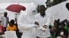 A volunteer health worker practices using a personal protective equipment (PPE) suit at a newly-constructed Ebola virus treatment center in Monrovia, Liberia, Sept. 21, 2014.