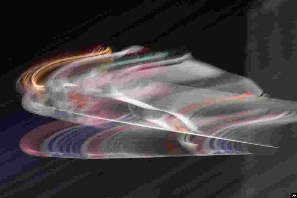 In this picture taken with a slow shutter speed, Junshiro Kobayashi of Japan soars through the air during a competition jump at the first stage of the 69th Four Hills ski jumping tournament in Oberstdorf, Germany.