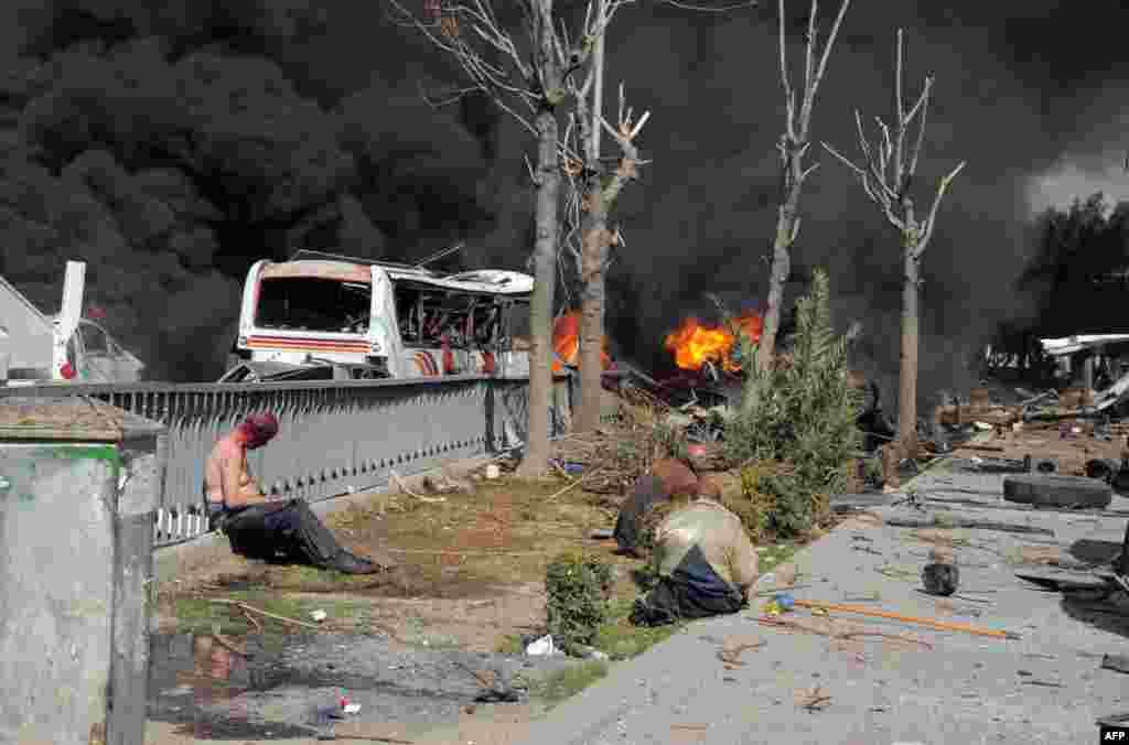 Turkish forensic officers prepare to remove a vehicle in front of the US consulate in Istanbul. Police detained one man after he threatened to detonate a bomb he said he was carrying. Bomb experts discovered he was not carrying a bomb.