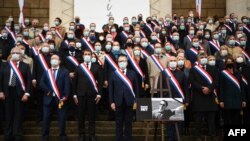 FILE - National Assembly president Richard Ferrand (C) stands among French MPs to pays tribute to slain teacher Samuel Paty, Oct. 20, 2020.