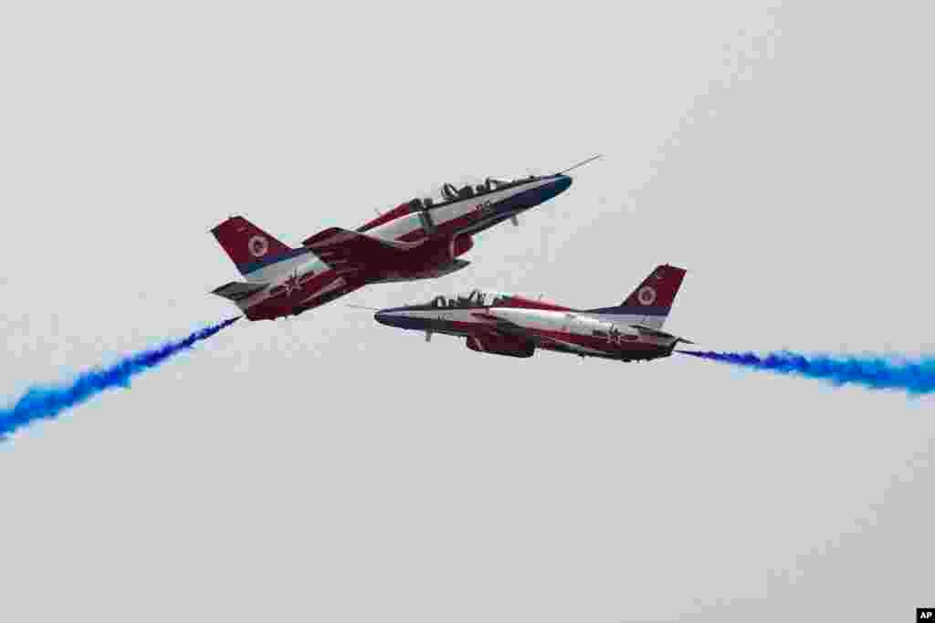 Members of the Chinese People's Liberation Army (PLA) Air Force Aviation University's "Red Falcon" Air Demonstration Team perform during the 13th China International Aviation and Aerospace Exhibition, also known as Airshow China 2021, in Zhuhai in southern Guangdong province.
