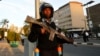 A riot policeman stands guard outside the main gate of the National Assembly in Kenya's capital Nairobi, Dec. 18, 2014. 