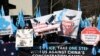 FILE - Uighurs and their supporters rally across the street from the United Nations headquarters in New York, March 15, 2018.