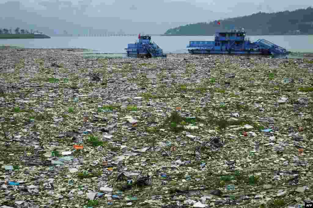 Workers in boats remove garbage from the Yangtze River in Yichang, in central China's Hubei province, China.