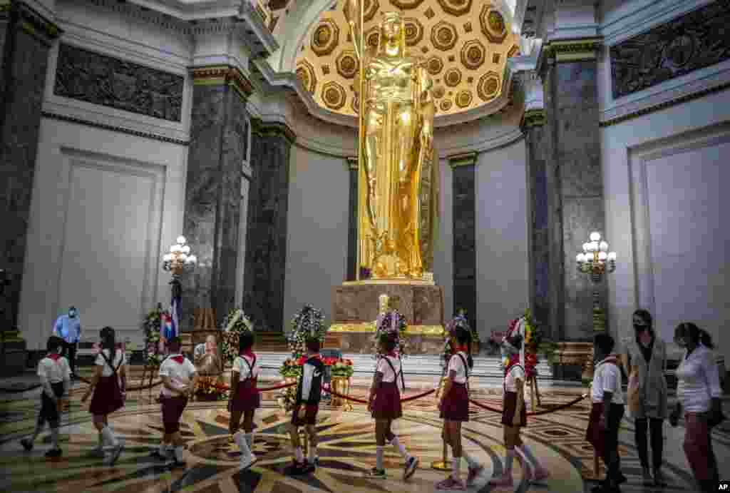 Students walk in a line to pay their last respects to Havana's Historian Eusebio Leal during his funeral ceremony inside the "Salon de Los Pasos Perdidos" where his ashes are on display at the Capitol in Havana, Cuba.