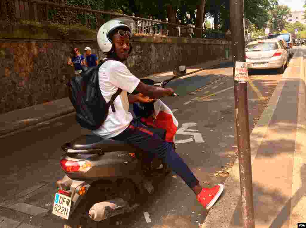 A French fan is all geared up for the game in national colors, in Paris, France, July 15, 2018. (L. Bryant/VOA)