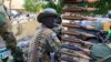 FILE - A South Sudan army soldier stands next to a machine gun mounted on a truck in Malakal town, some 500 km (312 miles) northeast of the capital, Juba.