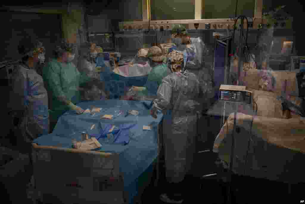 Doctors perform a traqueostdmy on a COVID-19 patient in critical care in Barcelona's Hospital del Mar the Intensive Care Unit, Spain.
