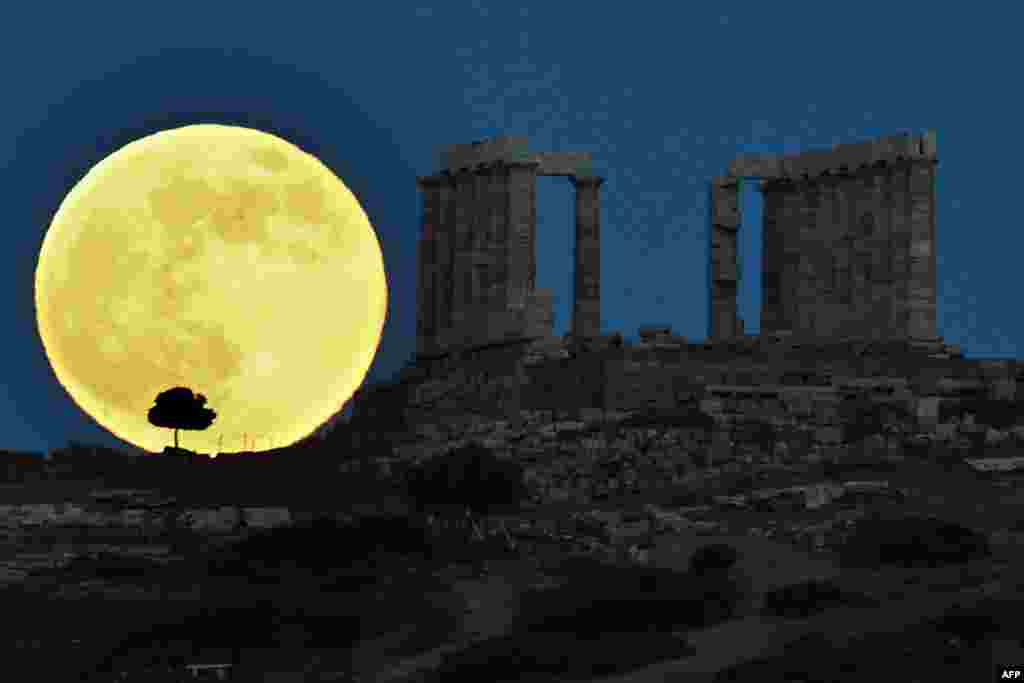 A supermoon rises next to the ancient Greek temple of Poseidon at Cape Sounion, some 65 kilometers south of Athens, June 23, 2013.