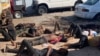 Les quatorze personnes qui ont survécu à la tragédie sont couchés à terre. (Photo: Andre Batista / VOA)