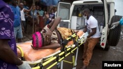 A pregnant woman suspected of contracting Ebola is lifted by stretcher into an ambulance in Freetown, Sierra Leone Sept. 19, 2014 in a handout photo provided by UNICEF.