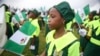 A school girl holds a Nigerian flag as she joins a parade marking Nigeria's 54th Independence Day in Lagos October 1, 2014.